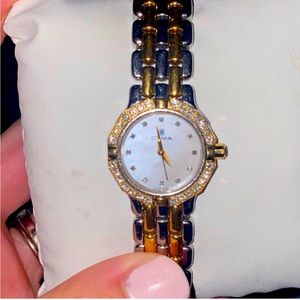 Diamond bezel, mother of Pearl watch face. Silver and gold detail